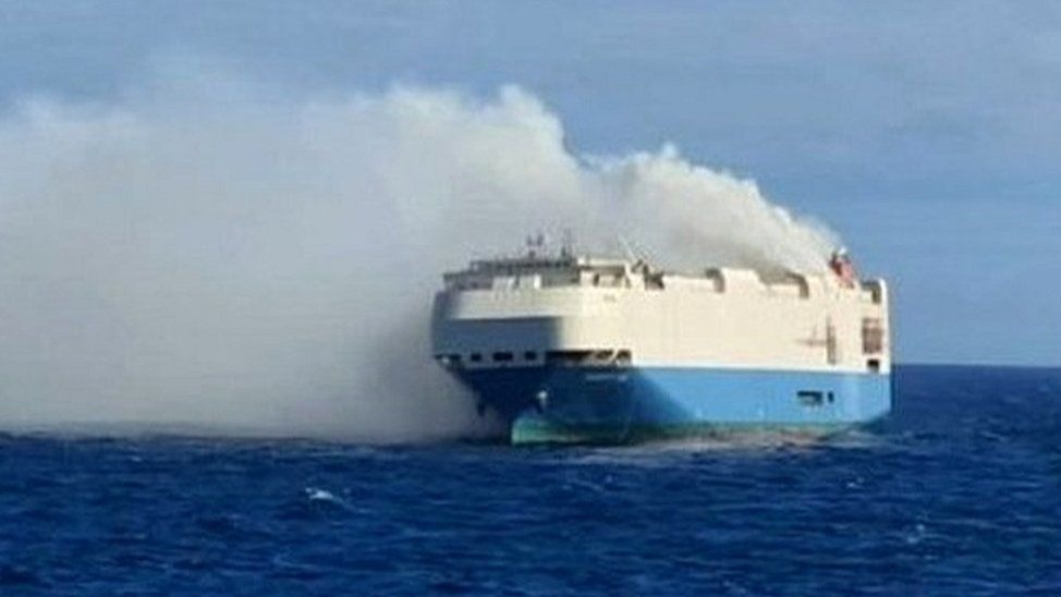 Luxury car in smoke after a ship catches fire.